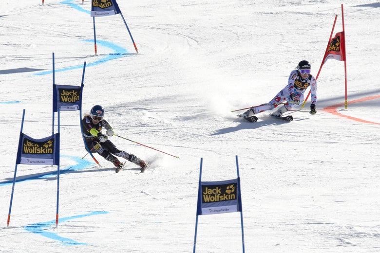 US Mikaela Shiffrin (L) competes with France's Nastasia Noens during the nation team event at the Alpine Skiing World Cup finals on March 14, 2014 in Lenzerheide. Switzerland beat the United States to win the mixed team event at the World Cup finals on home snow at Lenzerheide. AFP PHOTO / FABRICE COFFRINI (Photo credit should read FABRICE COFFRINI/AFP/Getty Images)